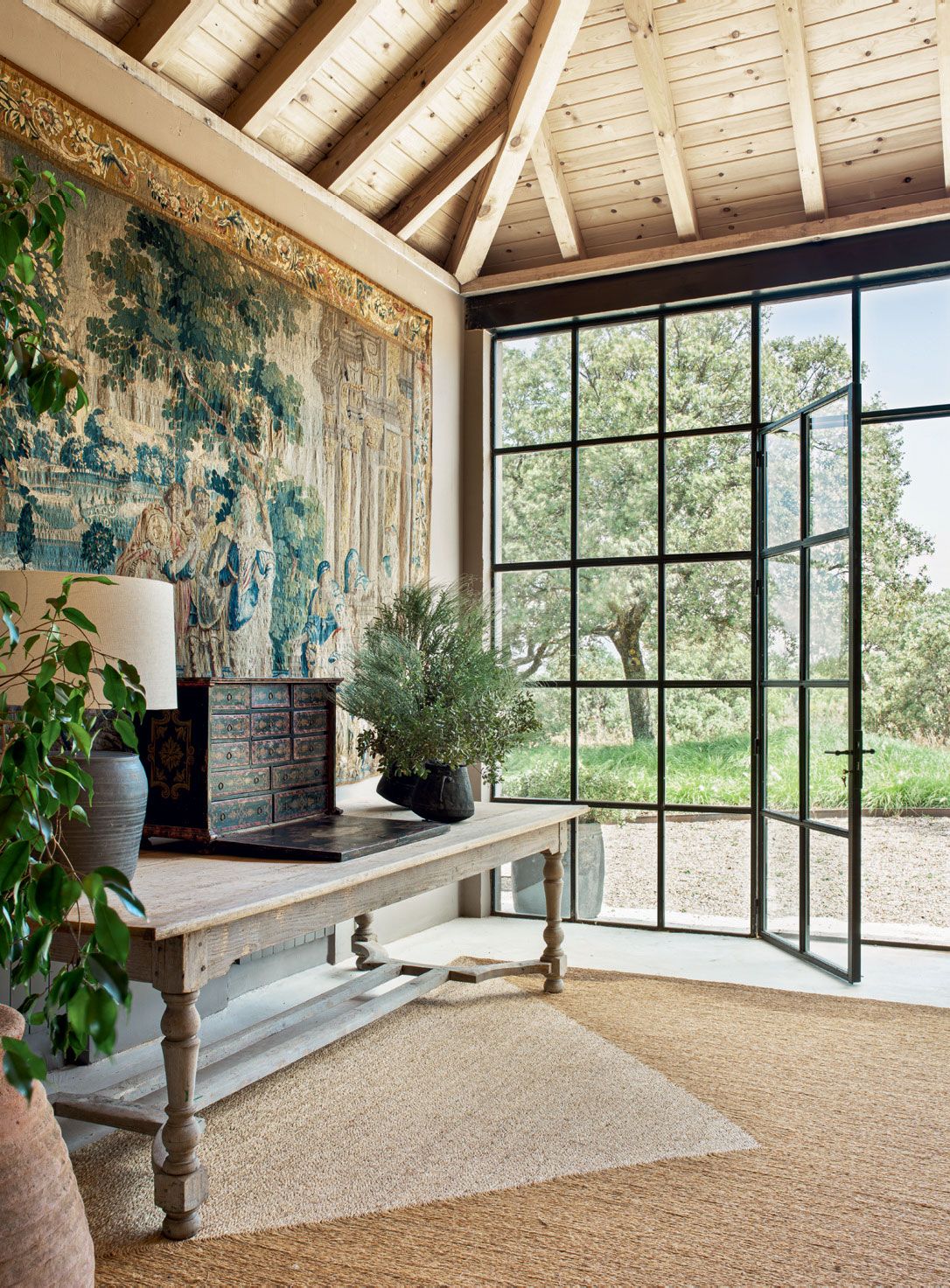 A 16thcentury Belgian tapestry hangs above an antique French table in this new structure adjacent to the old part of the...