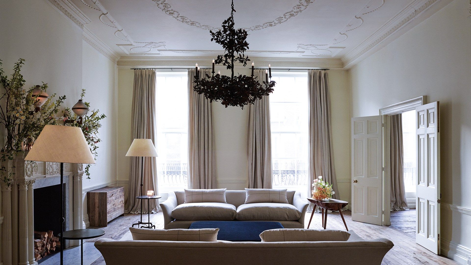 Image may contain Living Room Indoors Room Furniture Couch Lamp and Chandelier