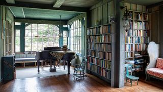 Image may contain Flooring Wood Furniture Hardwood Floor Chair Bookcase Shelf Indoors and Leisure Activities