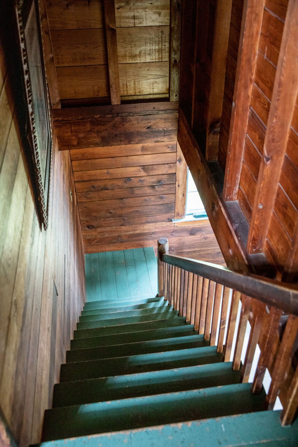Upstairs the ﬁr walls have remained raw since the cottage was built.