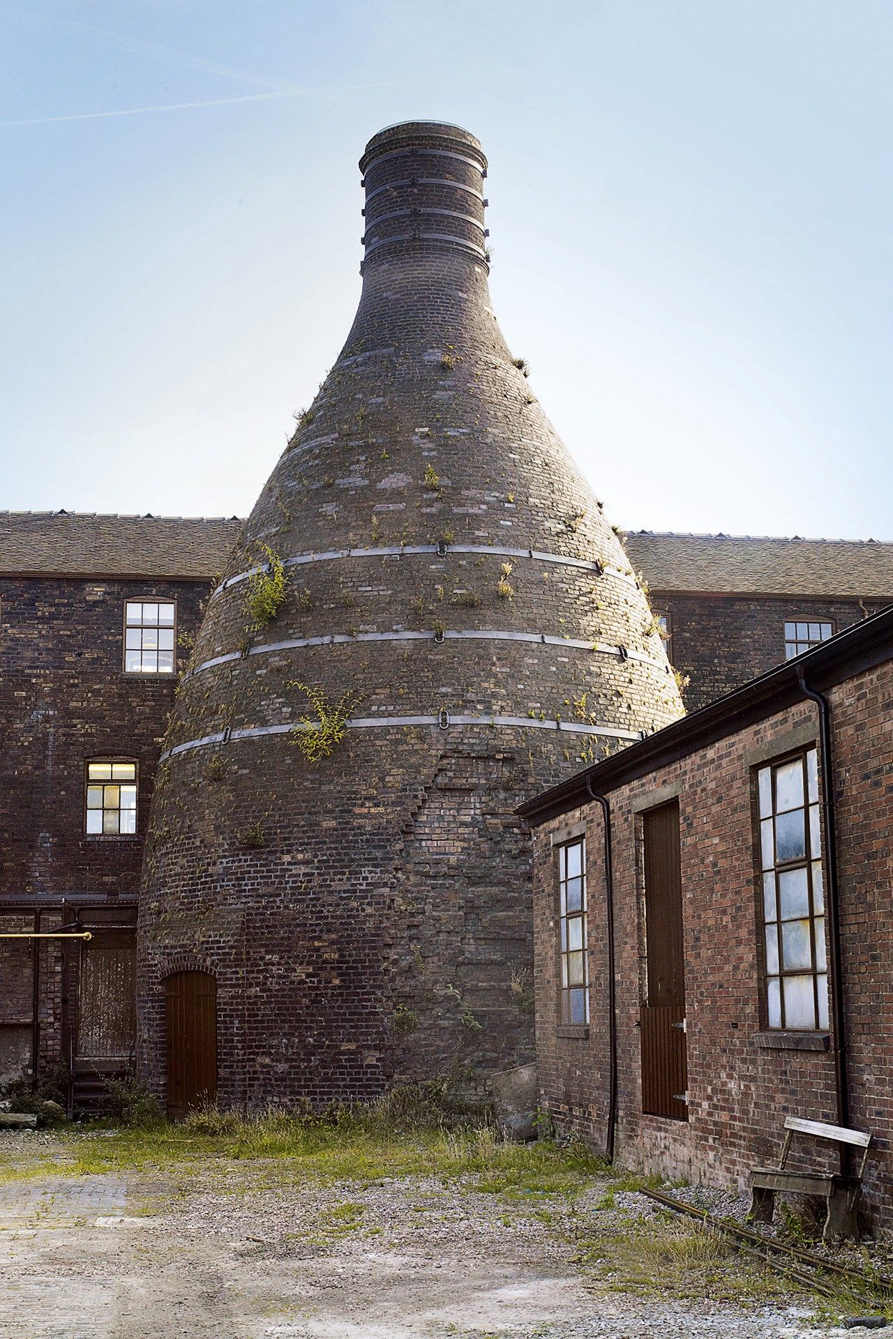 Image may contain Brick Building Architecture Furniture Bench Steeple Spire Tower and Roof
