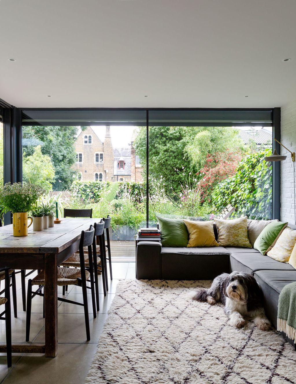 Image may contain Furniture Couch Living Room Room Indoors Table Rug Interior Design Animal Dog Mammal and Pet