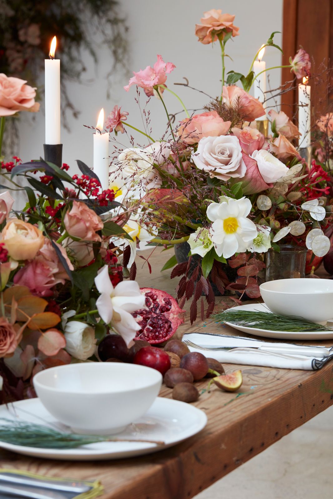 Image may contain Candle Plant Human Person Flower Blossom Flower Arrangement Flower Bouquet Pottery and Saucer