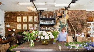 Image may contain Human Person Plant Flower Flower Arrangement Blossom Flower Bouquet Church Altar and Architecture