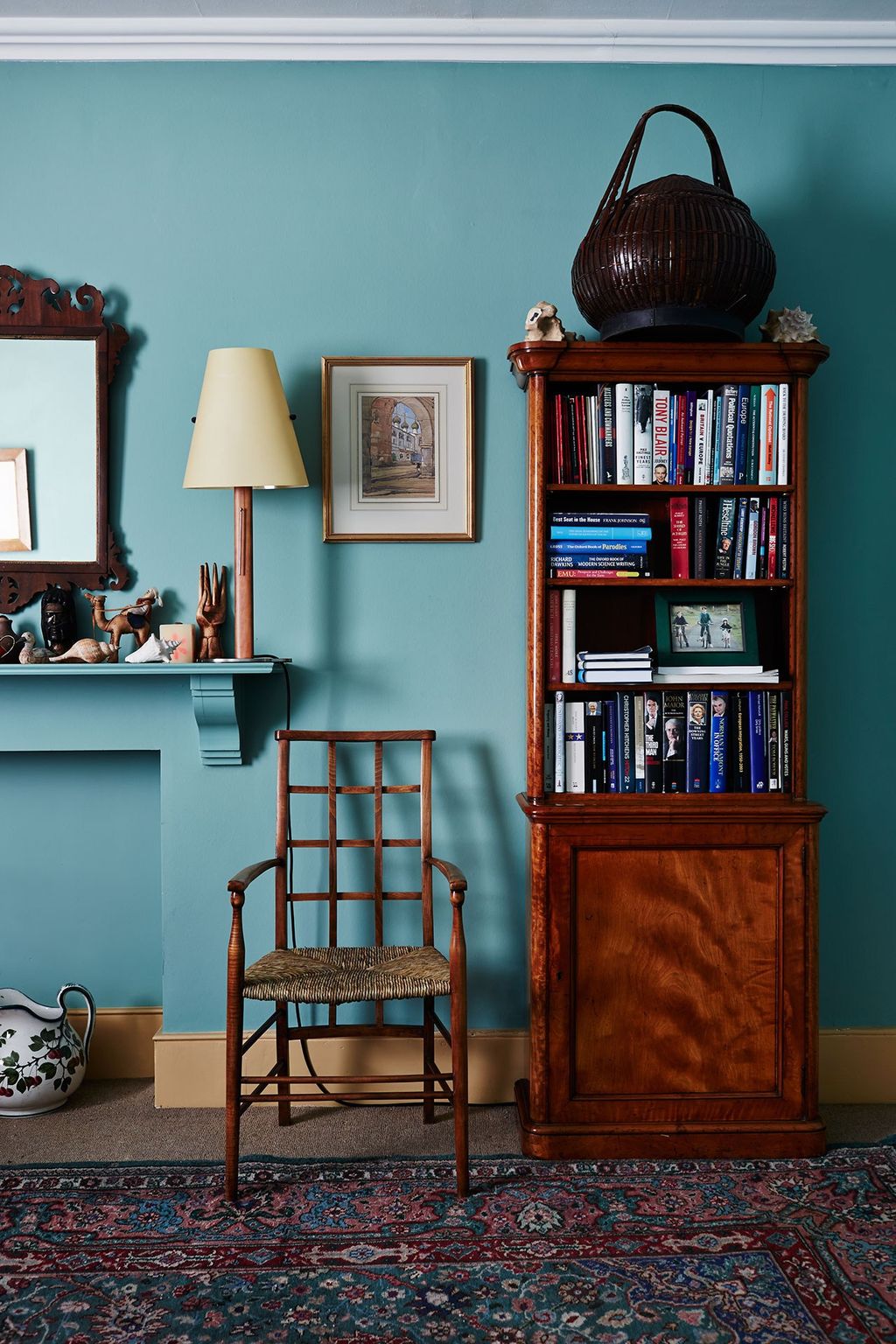 Image may contain Furniture Bookcase Shelf Interior Design Indoors Lamp Living Room Room Couch Chair and Rug