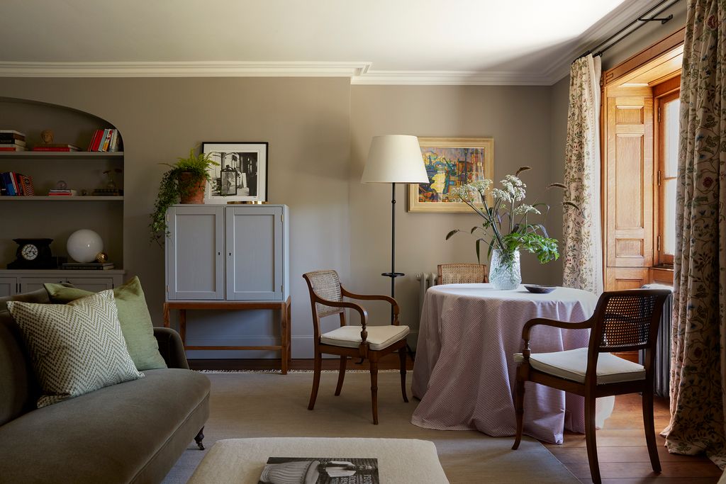 Image may contain Living Room Indoors Room Home Decor Furniture Chair Interior Design Couch Flooring and Table