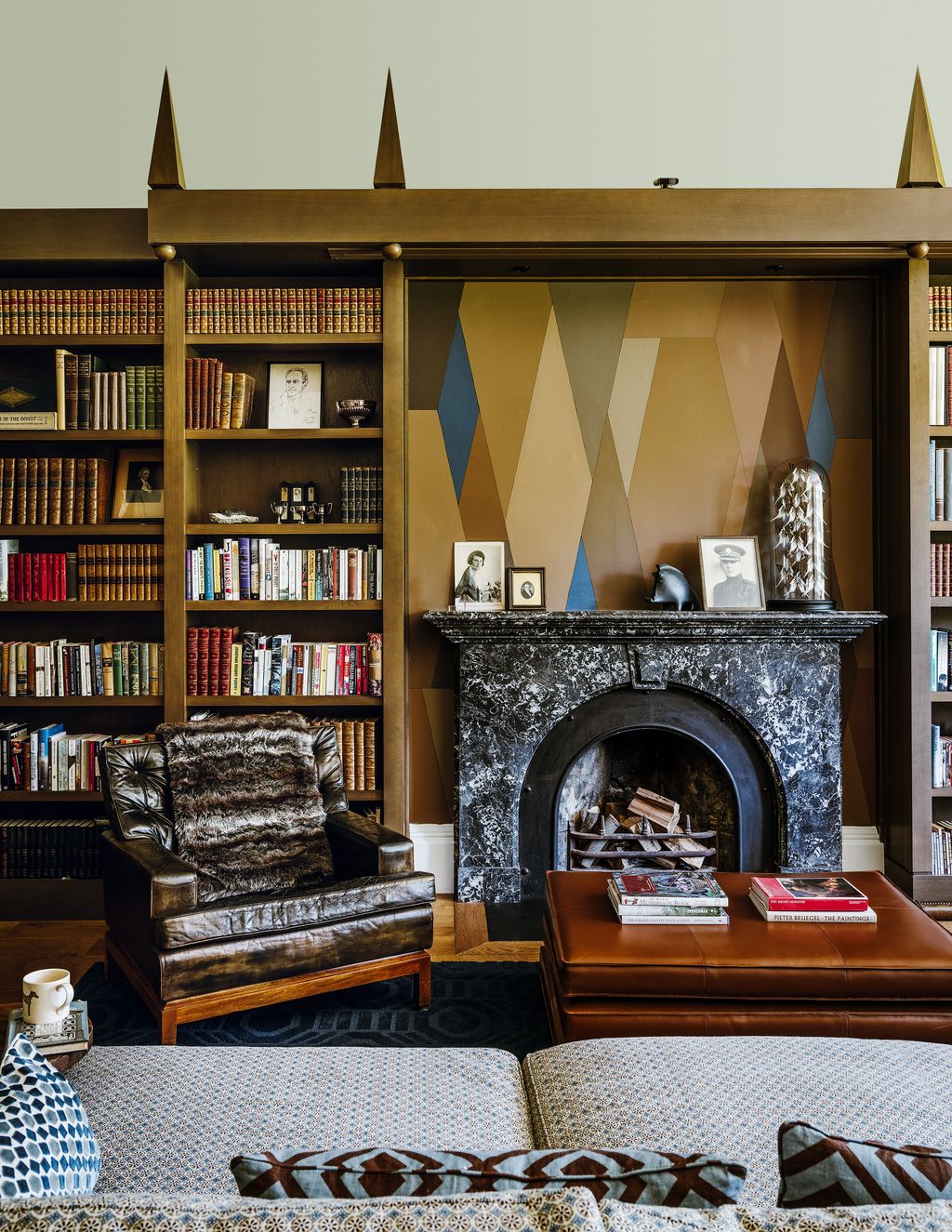 Image may contain Furniture Bookcase Indoors Room Shelf Living Room Interior Design and Rug