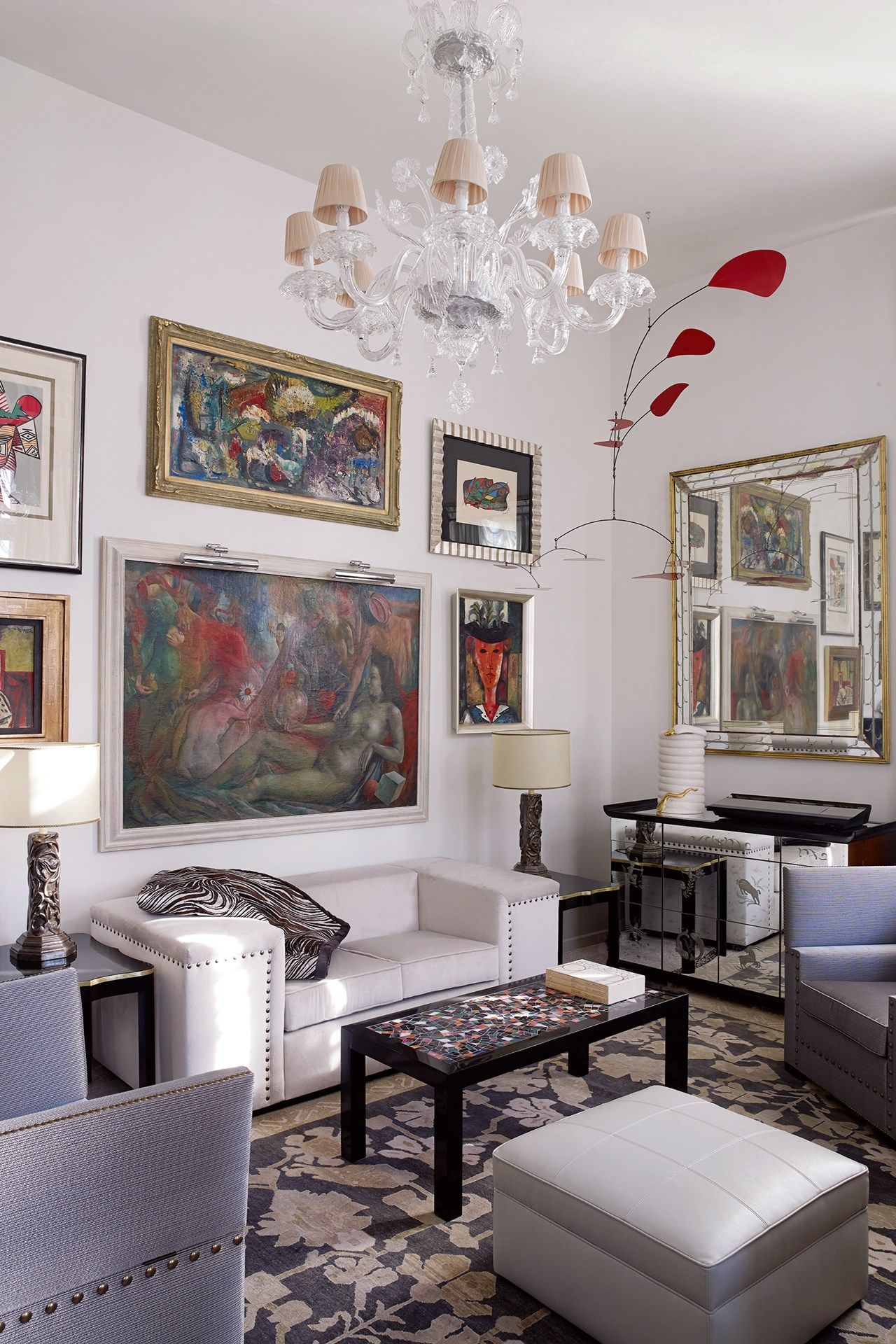 Image may contain Furniture Living Room Indoors Room Table Interior Design Coffee Table Rug Lamp and Chandelier