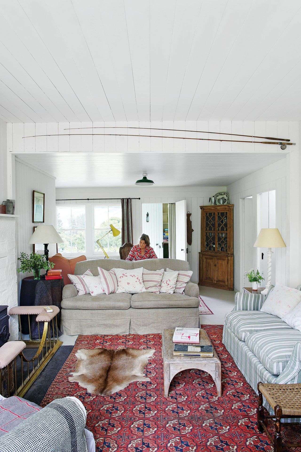 Image may contain Living Room Room Indoors Furniture Couch Human Person Interior Design Rug and Cushion