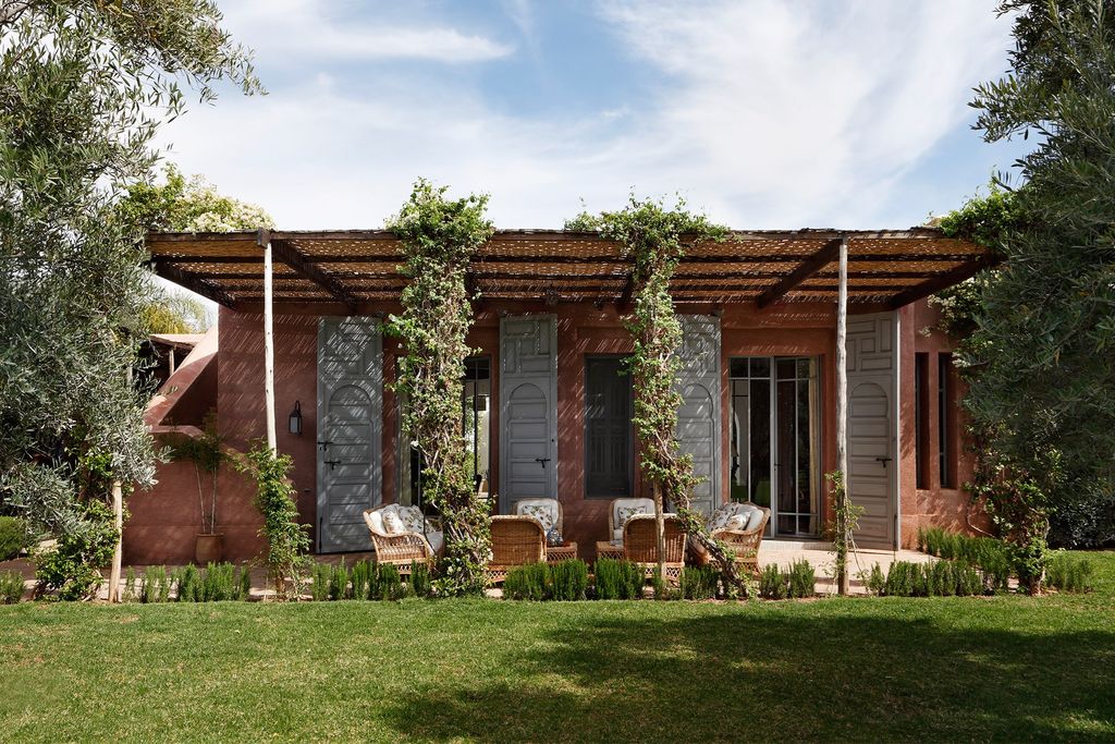 Image may contain Patio Outdoors Porch Nature Pergola Building Housing Plant Countryside Grass Shelter and Rural