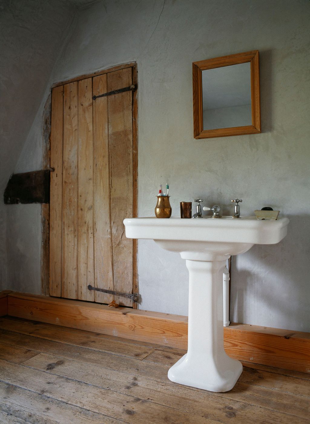 The bathroom retains its original planked door.