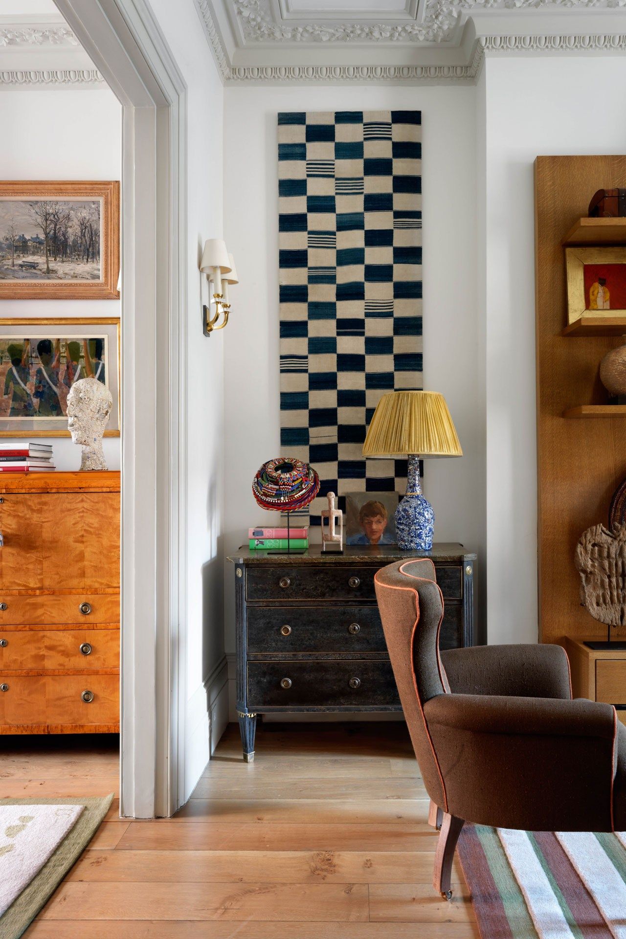 Image may contain Furniture Shelf Chair Interior Design Indoors Living Room Room Wood Bookcase Flooring and Human