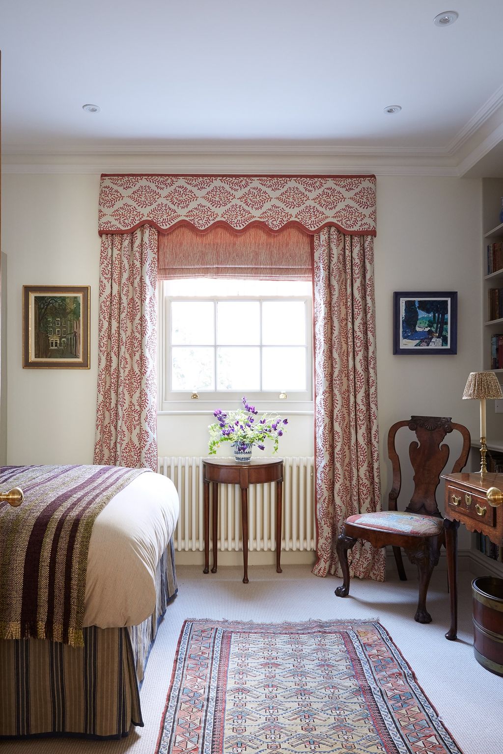 Image may contain Living Room Room Indoors Furniture Bedroom Interior Design Rug Flooring Wood Bed and Plant