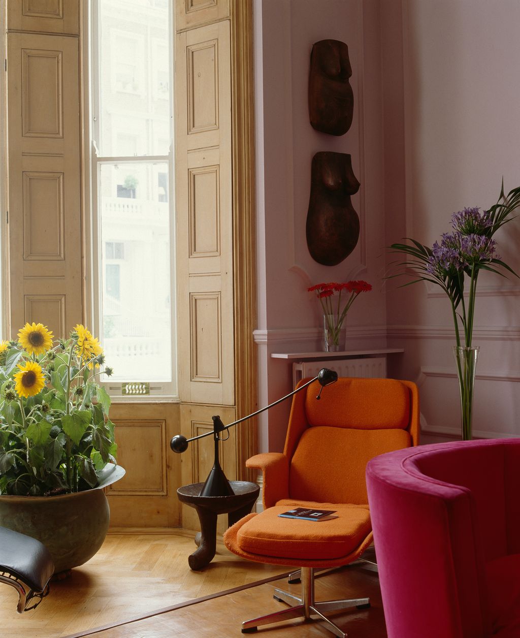 Image may contain Furniture Living Room Room Indoors Interior Design Plant Flooring Couch Chair Flower and Blossom