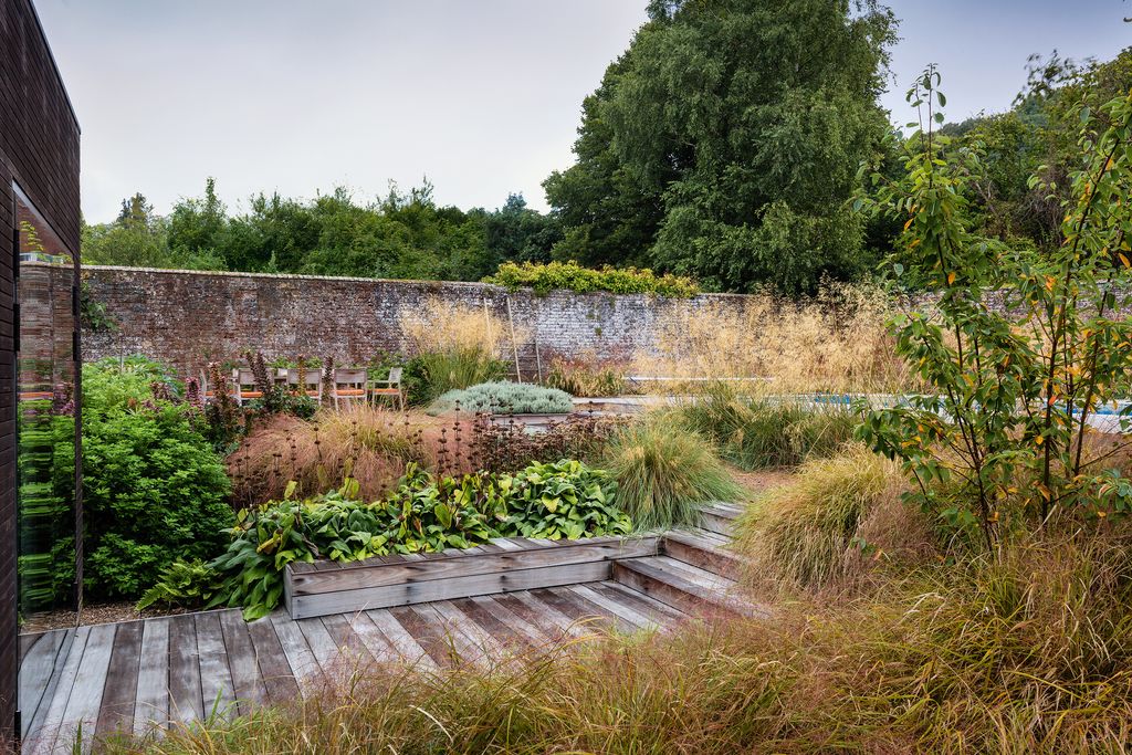 Image may contain Plant Outdoors Vase Pottery Potted Plant Jar Building Planter Boardwalk Bridge Nature and Herbs