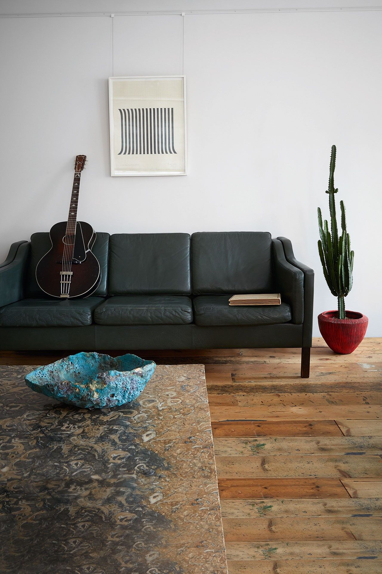 Image may contain Furniture Couch Living Room Room Indoors Rug Leisure Activities Musical Instrument and Guitar