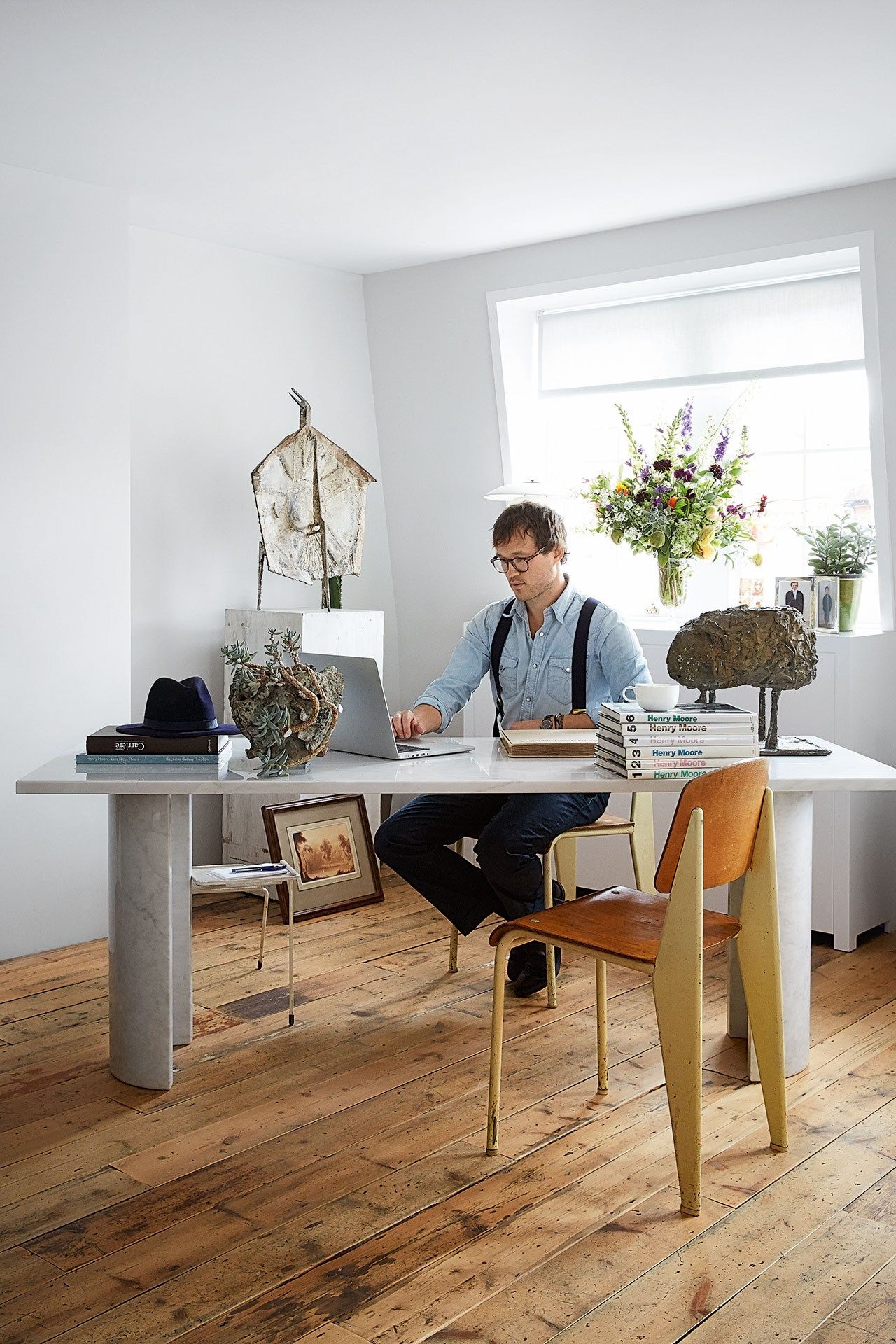 Image may contain Wood Flooring Human Person Hardwood Furniture Chair Indoors Interior Design Table and Plywood