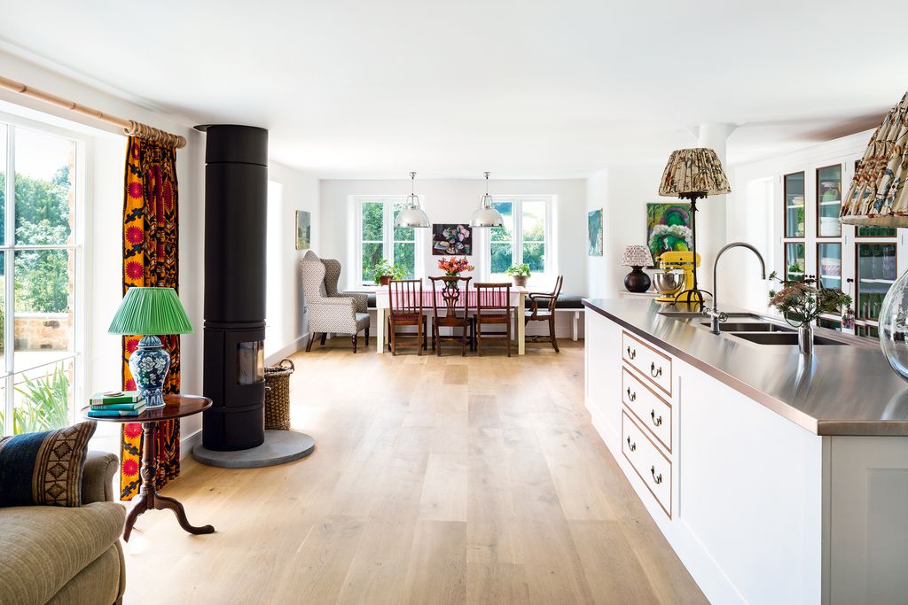 Image may contain Flooring Floor Interior Design Indoors Room Living Room Wood Furniture Chair and Hardwood