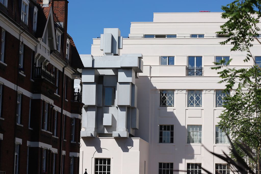 Image may contain City Town High Rise Building Urban Apartment Building Home Decor Human Person and Office Building