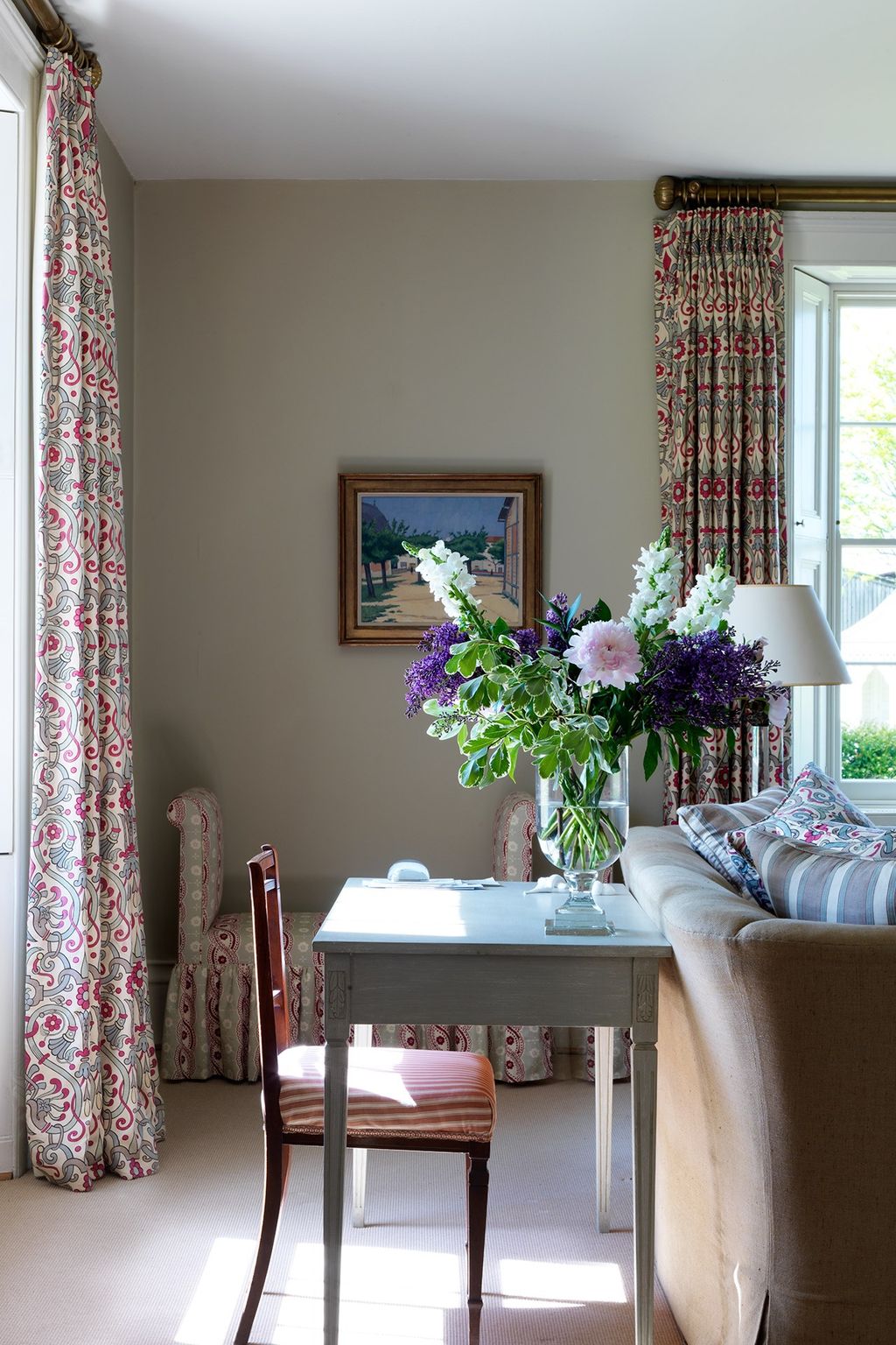 Image may contain Living Room Room Indoors Furniture Chair Couch Interior Design Plant Table Flower and Blossom