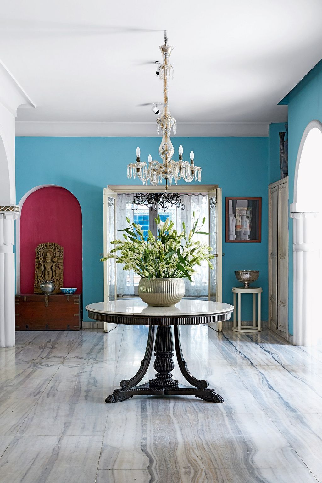 Image may contain Flooring Floor Indoors Interior Design Plant Room Furniture Living Room Dining Room and Flower