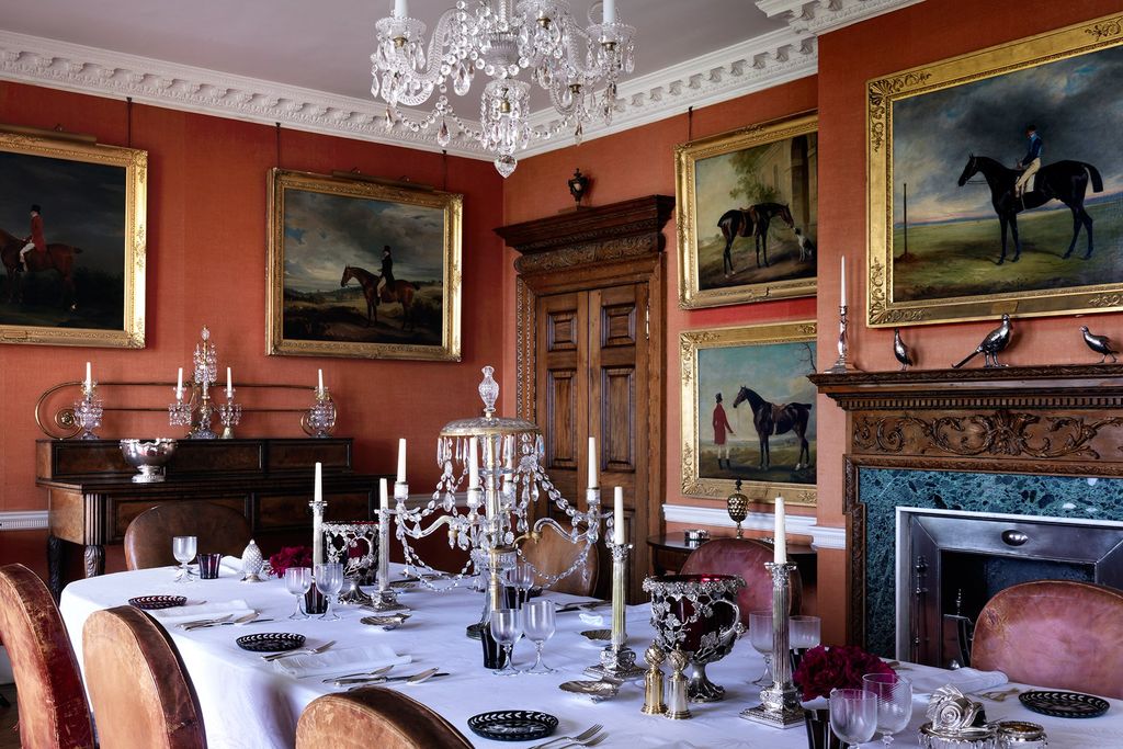 Image may contain Furniture Glass Indoors Room Home Decor Animal Horse Mammal Dining Table Table and Goblet