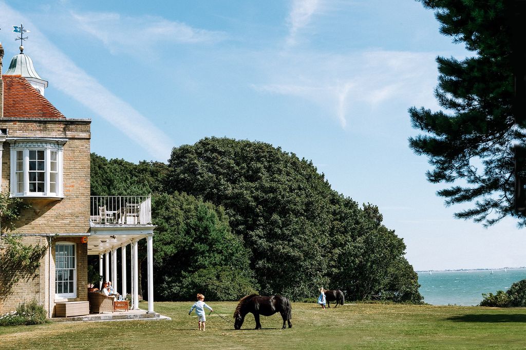 Image may contain Grass Plant Human Person Animal Mammal Horse Outdoors Nature Field Grassland Lawn and Spire