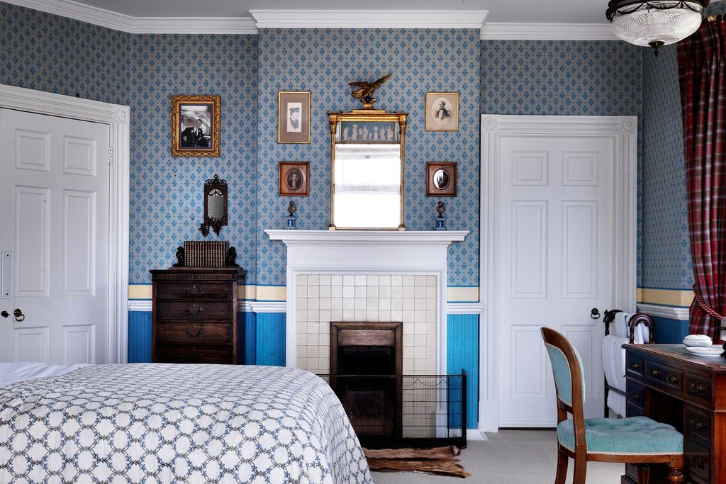 Image may contain Furniture Indoors Chair Fireplace Hearth Room Home Decor and Bedroom