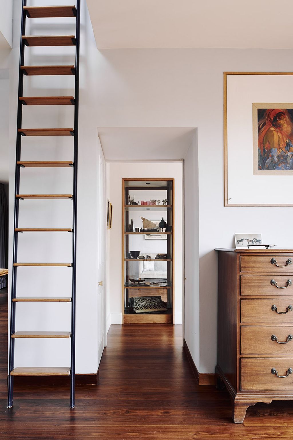 Image may contain Furniture Wood Flooring Shelf Interior Design Indoors Hardwood Corner Cabinet and Housing