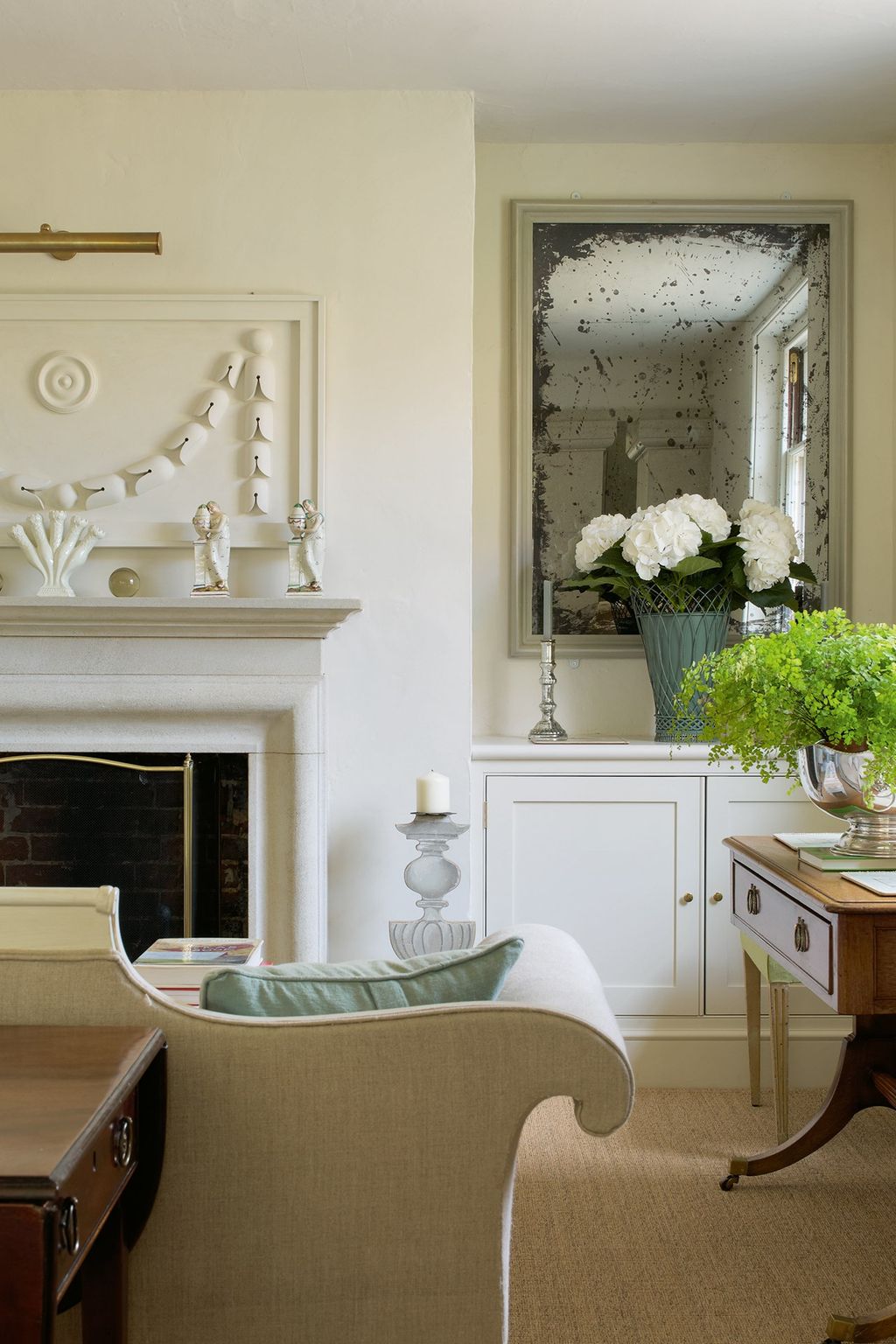 Image may contain Furniture Interior Design Indoors Living Room Room Plant Fireplace Hearth Flower and Blossom