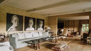 Image may contain Flooring Human Person Wood Furniture Couch Living Room Room Indoors Hardwood Floor and Table