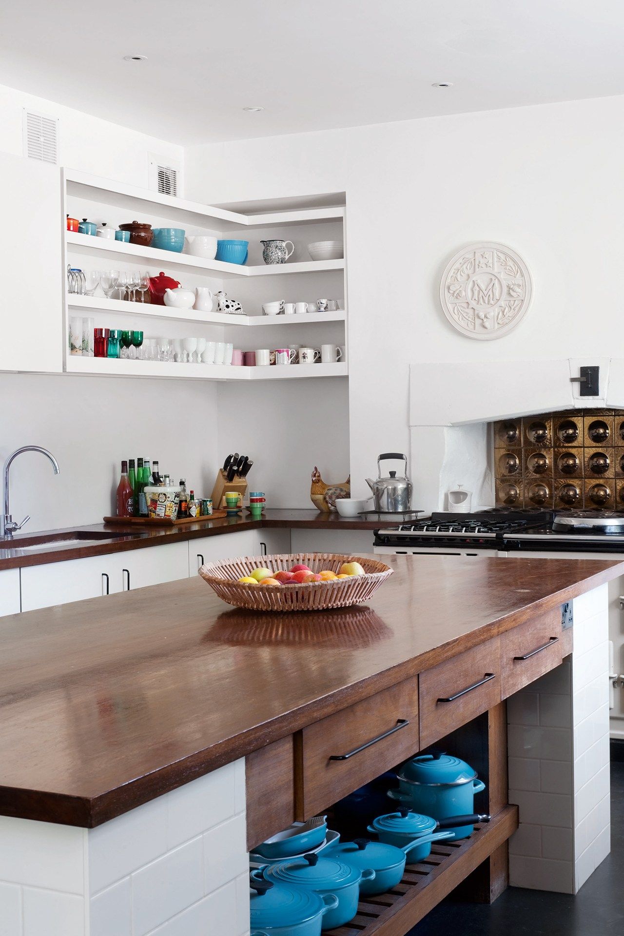 Image may contain Indoors Room Kitchen Kitchen Island Shelf and Furniture