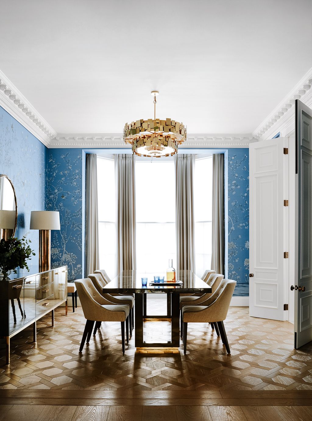 Dining Room De Gournays ‘Earlham handpainted silk wallpaper in sky blue creates an opulent backdrop for metallic...