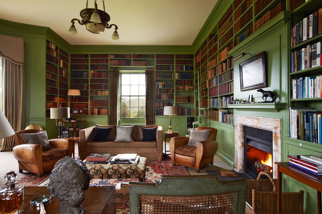 Image may contain Living Room Room Indoors Furniture Couch Interior Design Chair Hearth Fireplace and Electronics