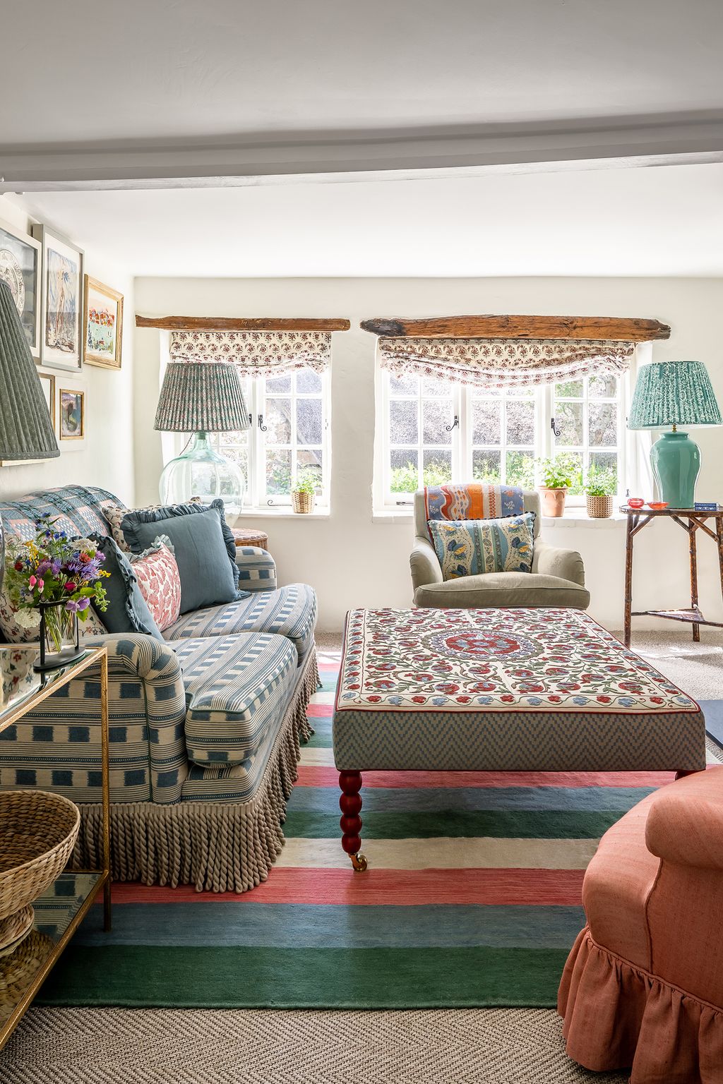 Image may contain Furniture Living Room Indoors Room Interior Design Couch Cushion Pillow Rug Home Decor and Table