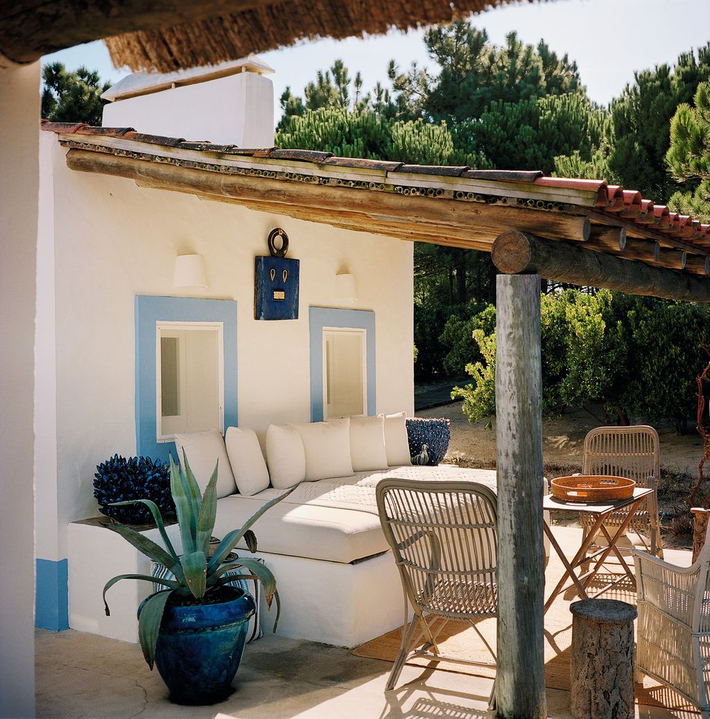 Image may contain Patio Porch Pergola Furniture Couch Wood Chair Living Room Room and Indoors