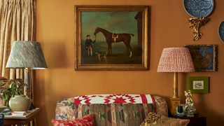 Image may contain Living Room Room Indoors Furniture Couch Animal Mammal Horse Lamp Table Lamp and Cushion
