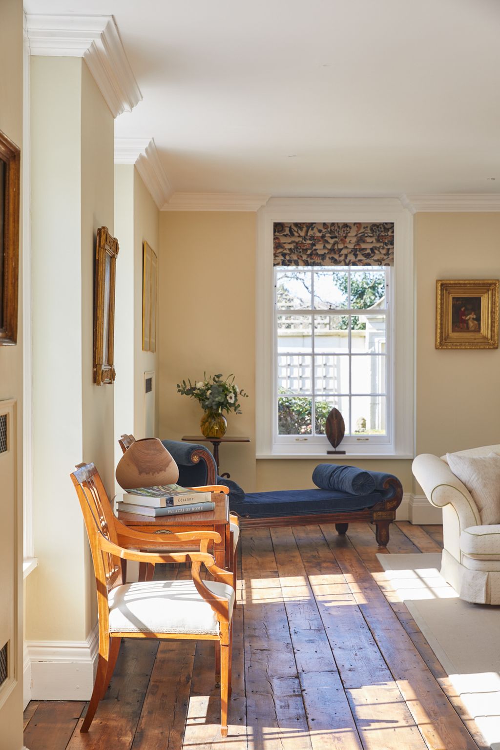 Image may contain Living Room Room Indoors Furniture Chair Flooring Wood Couch and Interior Design