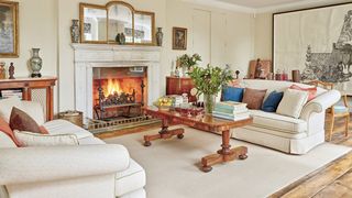 Image may contain Living Room Room Indoors Furniture Couch Interior Design Hearth Fireplace Table and Rug