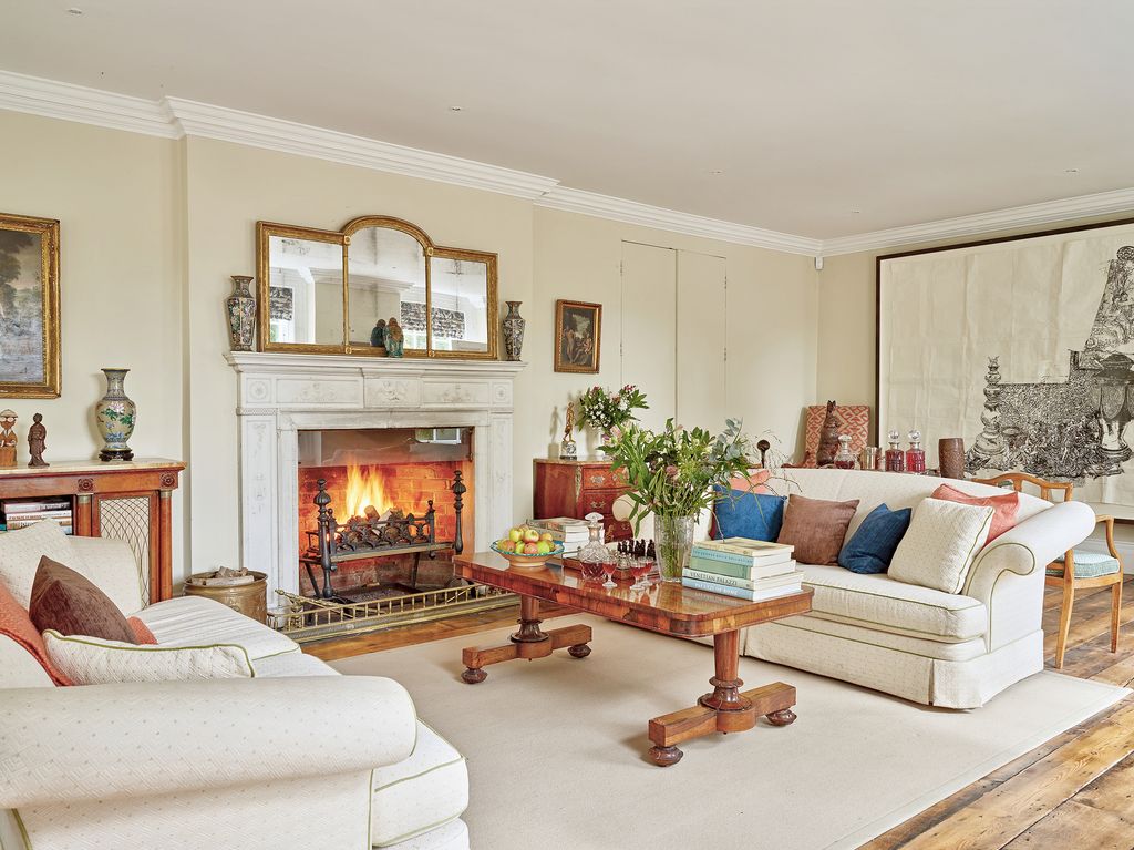 Image may contain Living Room Room Indoors Furniture Couch Interior Design Hearth Fireplace Table and Rug