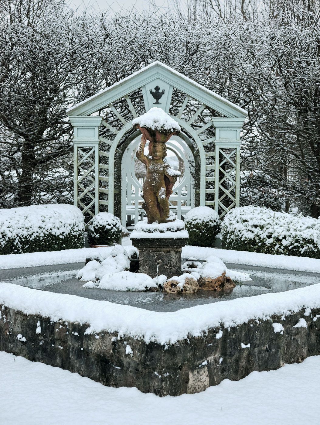 A putto a symbol of lifeenergy and peace stands on a ‘fountain of life in the centre of a diamondshaped pool at the...