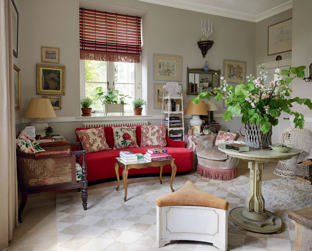 Image may contain Living Room Room Indoors Furniture Interior Design Couch Flooring Rug Table and Lobby