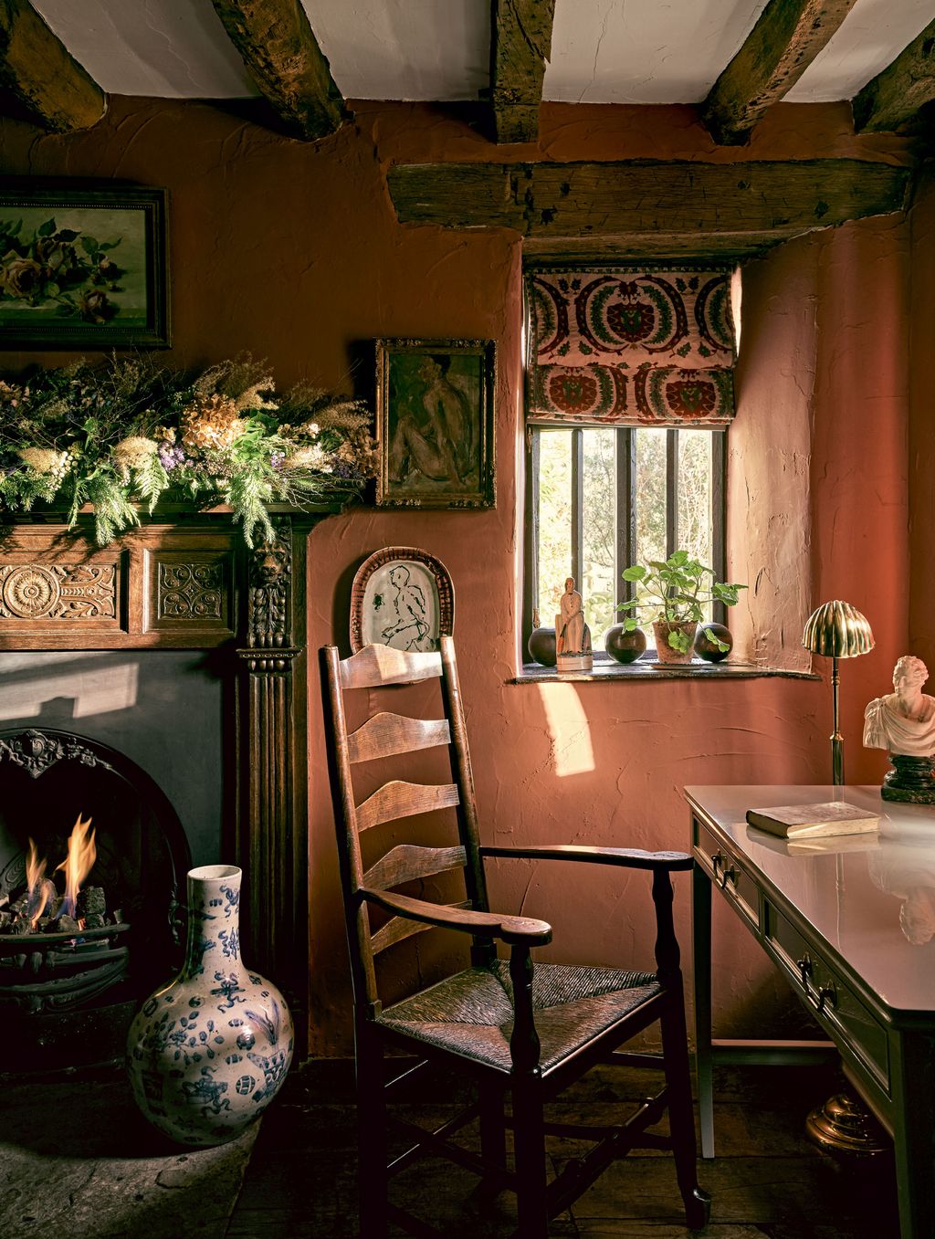 The walls of what used to be a music room are painted in Farrow  Balls earthy ‘Picture Gallery Red complementing a blind...