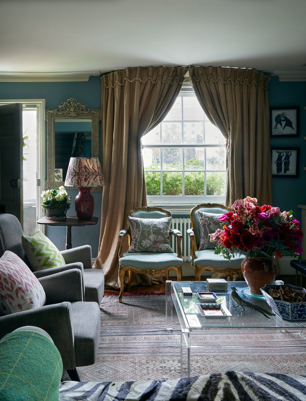 Image may contain Living Room Room Indoors Interior Design Furniture Couch Plant Flower and Flower Arrangement