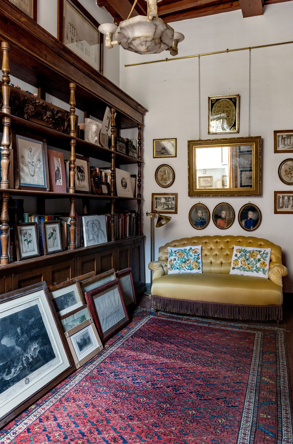 Image may contain Furniture Living Room Room Indoors Shelf Interior Design Couch Bookcase Rug and Flooring