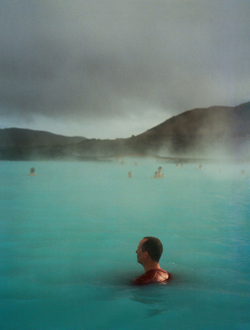 Swimmers enjoy the geothermal waters of the Blue Lagoon.