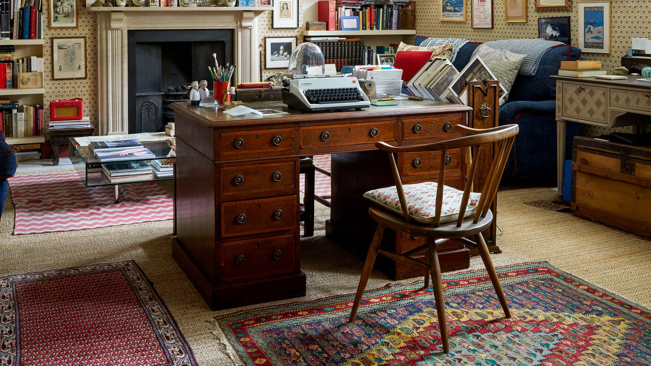 Image may contain Furniture Shelf Bookcase Table Living Room Room Indoors Desk Chair Interior Design and Human