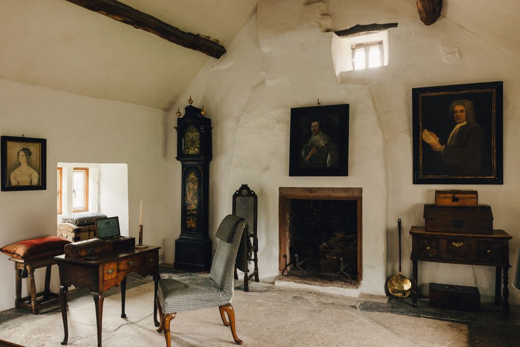 At the other end of the main bedroom a lacquer longcase clock stands in the corner and an early 17thcentury portrait of...