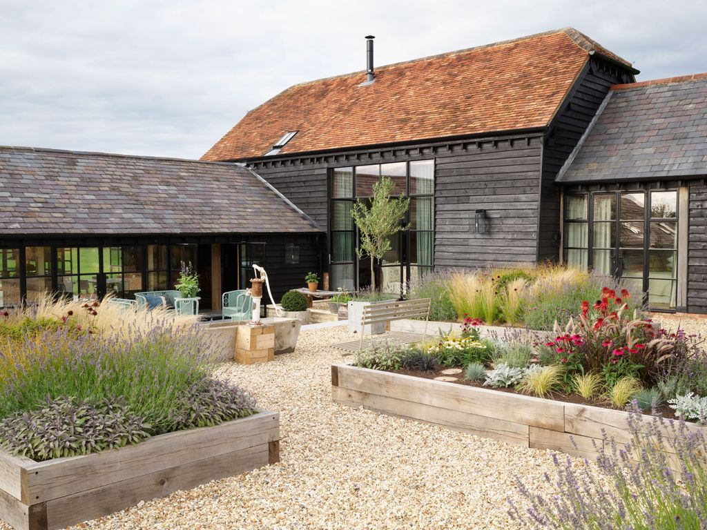 Together with various converted outbuildings this 19thcentury barn forms a spacious Lshaped house around a courtyard...