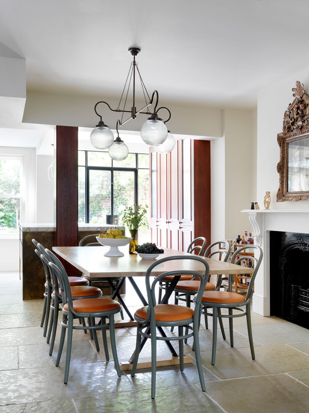 Image may contain Furniture Chair Indoors Room Living Room Interior Design Fireplace Dining Table and Table